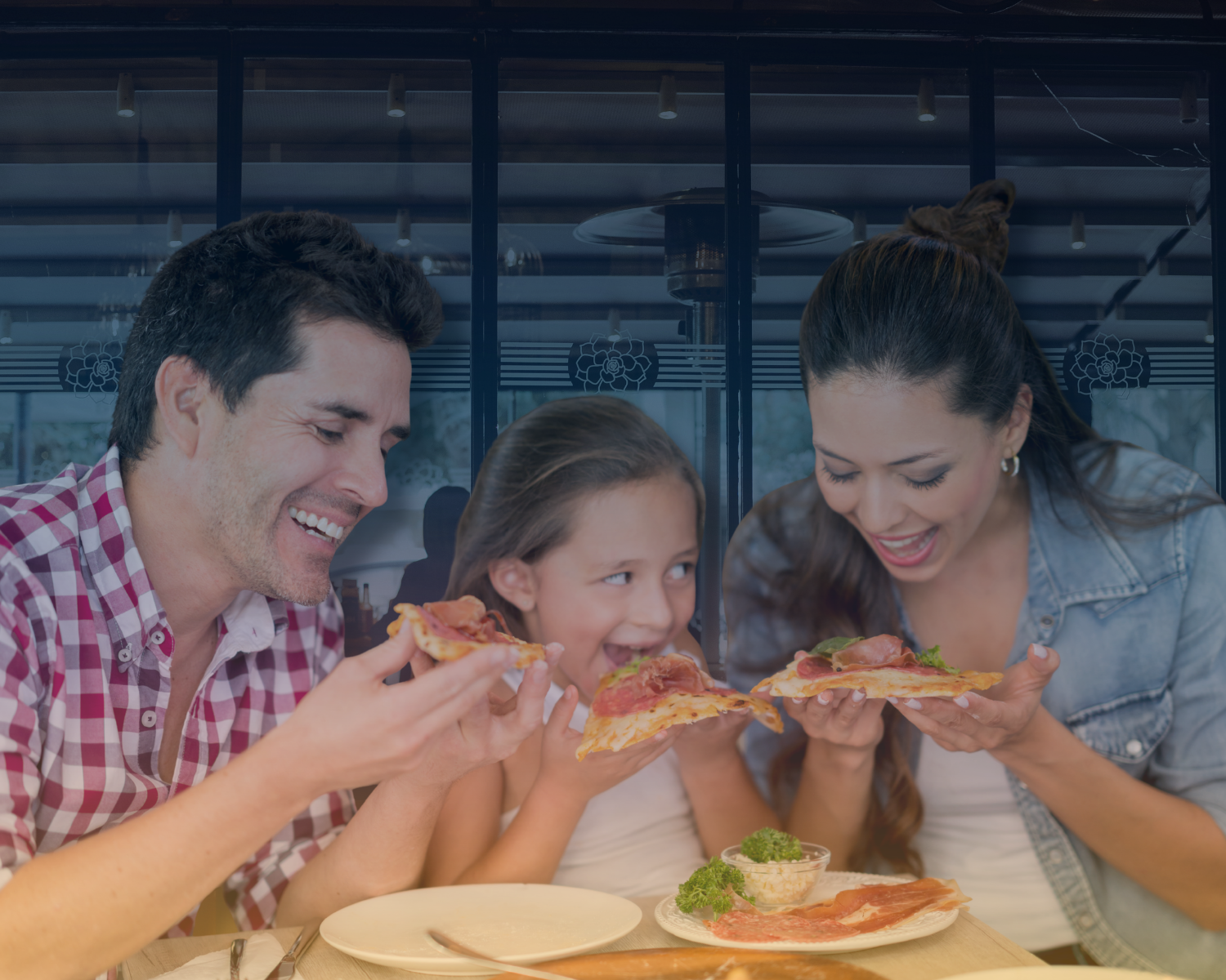 Happy family eating pizza at home, symbolizing comfort and stress-free probate and trust real estate services.