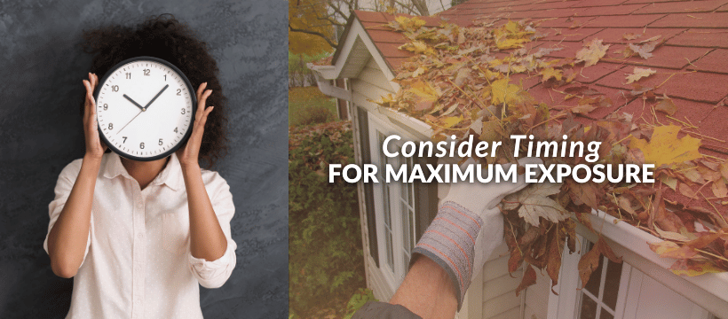 Person holding a clock with autumn leaves on a roof gutter, symbolizing seasonal timing.